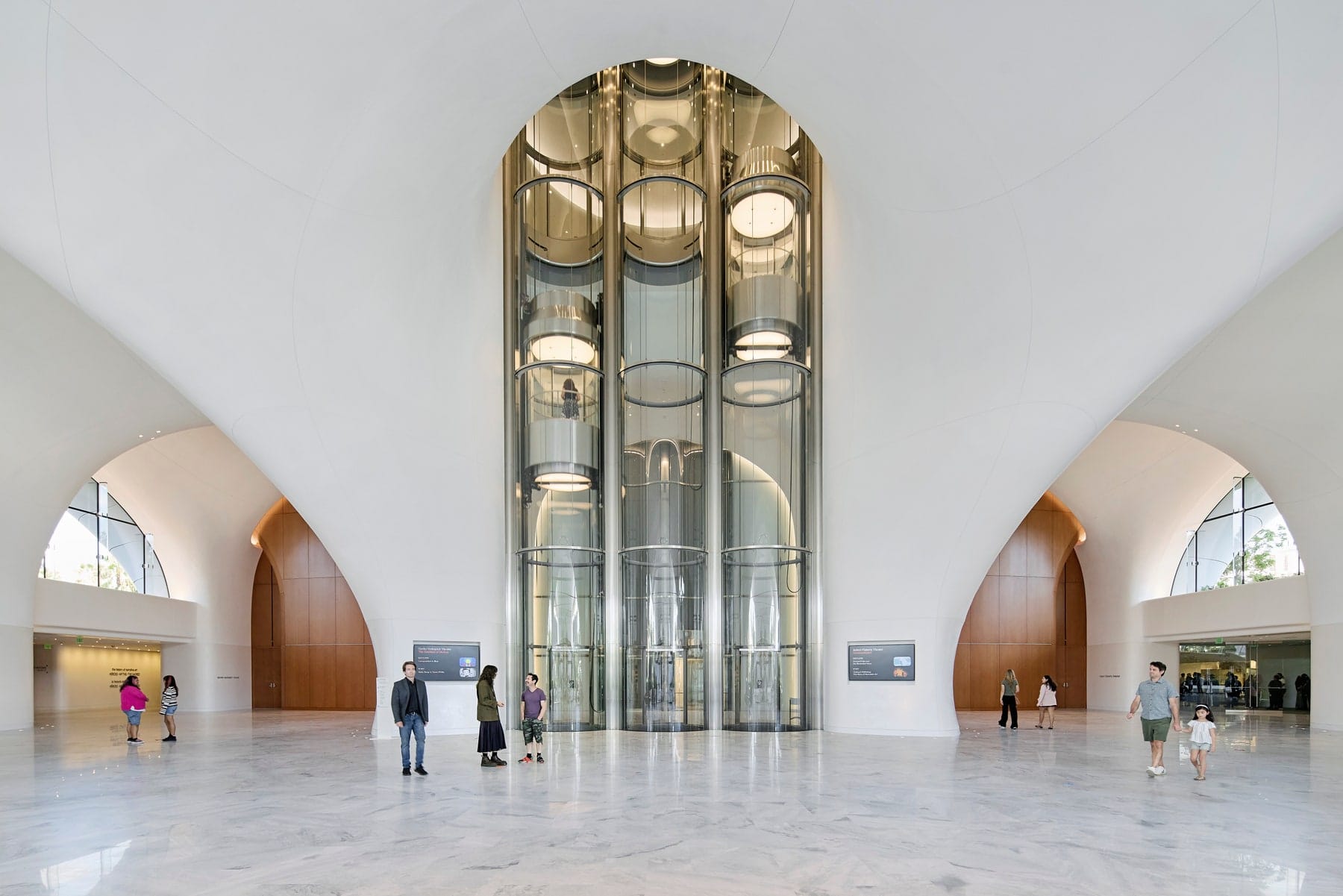 The soaring central lobby of the Lucas Museum of Narrative Art with its glass elevator shafts
