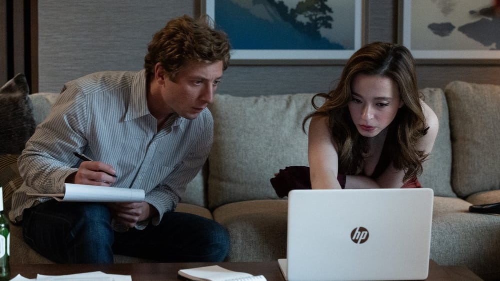 Jeremy Allen White and Mikey Madison looking at a laptop in The Social Reckoning